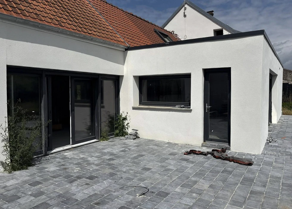 Maison individuelle avec extension moderne vitrée sous véranda à toiture plate
