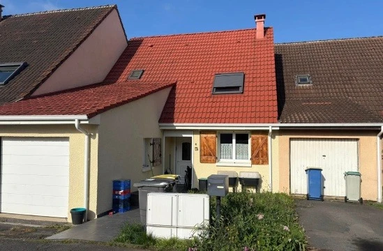 Toiture en tuiles terre cuite rouge avec installation de panneaux solaires thermiques noirs intégrés